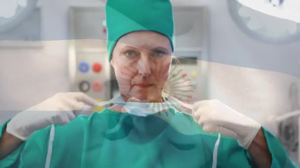 Animação Bandeira Argentina Acenando Sobre Cirurgião Sala Operações Medicina Global — Vídeo de Stock