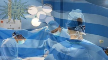 Ameliyathanede cerrahların üzerinde sallanan uruguay bayrağının animasyonu. küresel tıp, covid 19 pandemik konsept sırasında sağlık hizmetleri dijital olarak üretilen video.