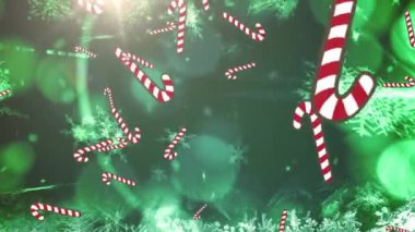 Düşen yılbaşı bastonunun ışıkları ve yeşil arka plandaki kar tanelerinin üzerine düşüşünün canlandırması. Noel, gelenek ve kutlama konsepti dijital olarak oluşturuldu.