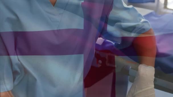 在手术室里 在女外科医生面前挥动英国国旗的动画 全球医学 围产期保健服务 数码制作的19种流行病概念视频 — 图库视频影像