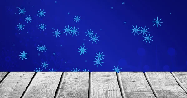 Image Falling Snowflakes Blue Background Wooden Floor Christmas Tradition Celebration — Stock Photo, Image