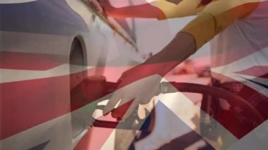 Benzin pompalarının üzerinde İngiliz bayrağı sallamanın animasyonu. Ulaşım ve yakıt sektörü konsepti dijital olarak oluşturulmuş video.