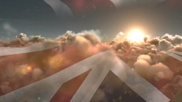 夕日と雪の結晶と雲の上に手を振っ英国のユニオンジャックフラグのアニメーション 愛国心独立コミュニティの概念をデジタルで生成したビデオです — ストック動画