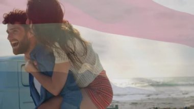 Sahilde eğlenen çiftin üzerinde Hollanda bayrağı sallamanın animasyonu. seyahat, tatiller, vatanseverlik ve dijital olarak üretilen video konsepti.