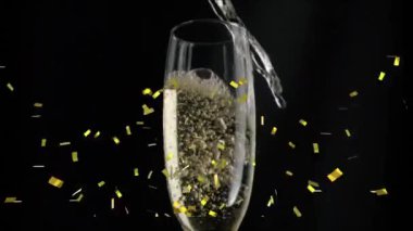 Şampanya kadehinin üzerine siyah arka planda düşen altın konfetilerinin animasyonu. Yılbaşı partisi kutlaması konsepti dijital olarak oluşturulmuş video.