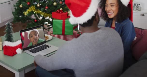 快乐的非洲裔美国夫妇在圣诞节的时候和儿子在电视上通话 圣诞节 节日和通信技术 — 图库视频影像