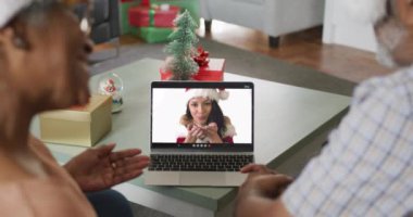 Mutlu Afro-Amerikan son sınıf çifti Noel 'de bayan arkadaşıyla görüntülü konuşma yapıyor. Noel, şenlik ve iletişim teknolojisi.