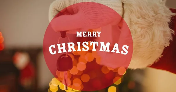 サンタクラス保持車のキーの手の上に陽気なクリスマステキストの構成 クリスマス冬伝統お祝いのコンセプトデジタルで生成されたイメージ — ストック写真