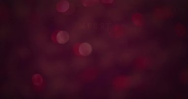 Mutlu noellerin animasyonu ve aydınlık noktalar üzerine mutlu yeni yıl metinleri. Noel, kış, gelenek ve kutlama konsepti dijital olarak oluşturulmuş video.