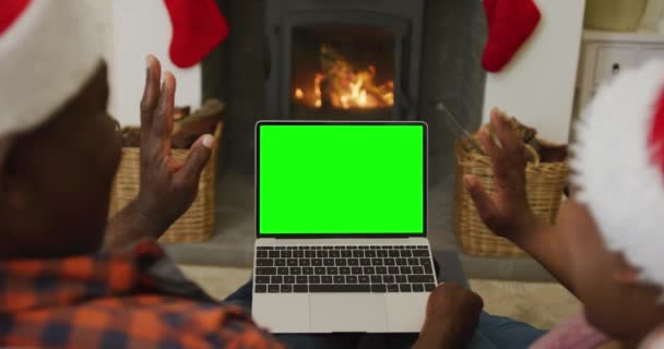 African American Couple Waving Santa Hats Making Laptop Christmas Video — Stock Video