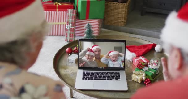高级高加索夫妇使用笔记本电脑进行圣诞视频通话 屏幕上有家人的微笑 圣诞节 节日和通信技术 — 图库视频影像
