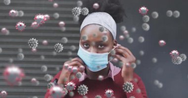 Yüz maskesi takan Afro-Amerikan bir kadın için Coperid 19 hücre animasyonu. küresel covid 19 salgın konsepti dijital olarak oluşturulmuş video.