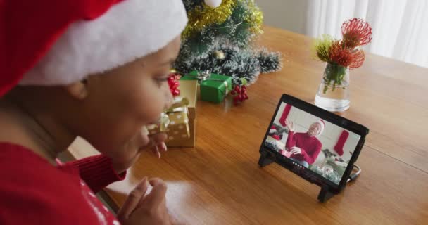 아프리카 미국인 모자쓰고 크리스마스 선물로 태블릿을 남자가 화면에 크리스마스 — 비디오