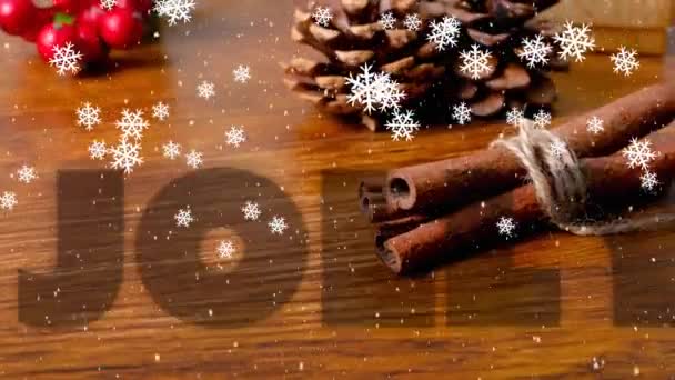 雪の落下やテーブルの上にクリスマスの装飾上の喜びのテキストのアニメーション クリスマス 伝統とお祝いのコンセプトデジタルで生成されたビデオ — ストック動画