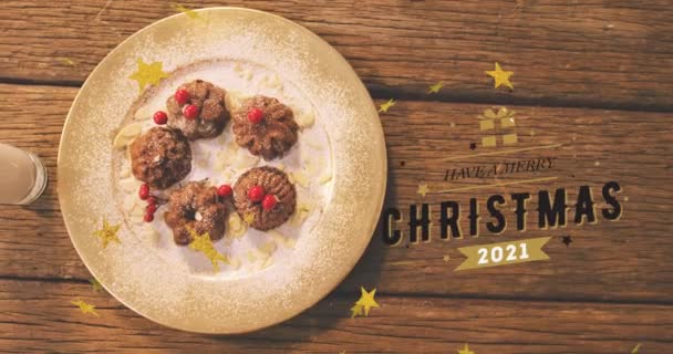 クリスマスクッキーの上に陽気なクリスマステキストのアニメーション クリスマス お祝いのコンセプトをデジタルで — ストック動画