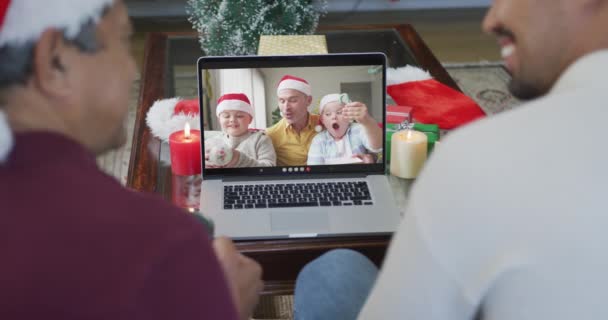 画面上の家族とクリスマスのビデオ通話のためのラップトップを使用して息子と出産の父親を笑顔 クリスマスやお祭りや通信技術は — ストック動画