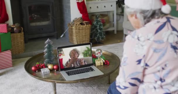 画面上の笑顔の女性とクリスマスのビデオ通話のためのラップトップを使用して白人のシニア女性 クリスマスやお祭りや通信技術は — ストック動画