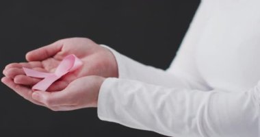 Kadın boksör ikonuyla savaş mesajı pankartı elinde pembe kurdele tutan bir kadının orta kısmına karşı. Göğüs kanseri farkındalığı kavramı