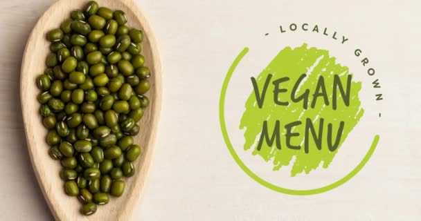 Animación Del Texto Del Menú Vegano Verde Sobre Brotes Verdes — Vídeo de stock