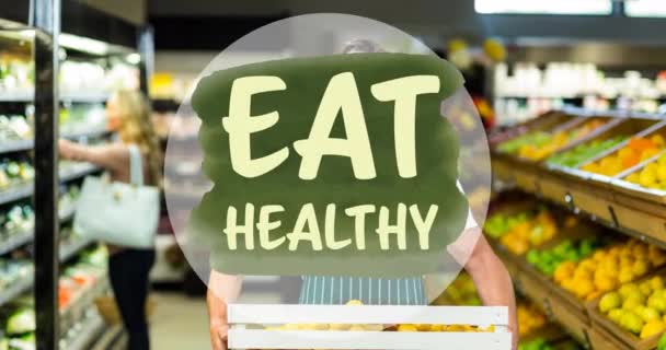 Animación Comer Texto Saludable Verde Sobre Hombre Sosteniendo Productos Tienda — Vídeo de stock