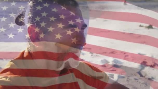 アメリカの旗のアニメーションビーチで高齢者の上に アメリカの歴史愛国心と独立の概念をデジタルで生成したビデオ — ストック動画