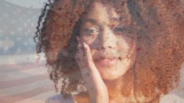 Sahildeki mutlu Afro-Amerikan kadını yerine Amerika Birleşik Devletleri bayrağının animasyonu. Amerikan tarihi, vatanseverlik ve bağımsızlık kavramı dijital olarak oluşturulmuş video.