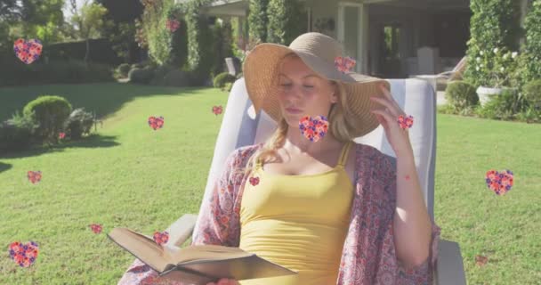 在花园里躺着看书的阳光下 花心的动画落在了高加索女人身上 快乐和幸福的概念数码视频 — 图库视频影像