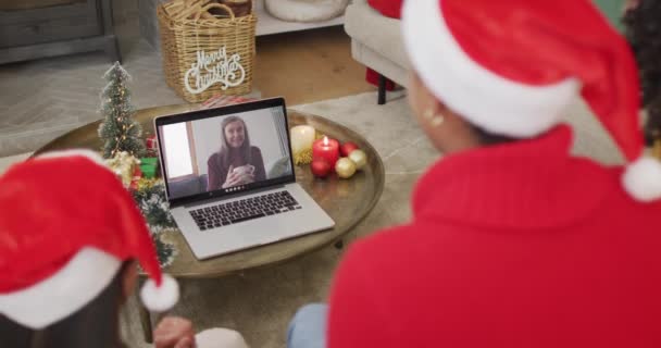 不同的家庭与桑塔帽使用笔记本电脑的圣诞视频通话与快乐的女人在屏幕上 圣诞节 节日和通信技术 — 图库视频影像
