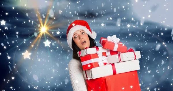 Composition Shocked Woman Santa Hat Carrying Stack Gifts Snowy Background — Stockfoto