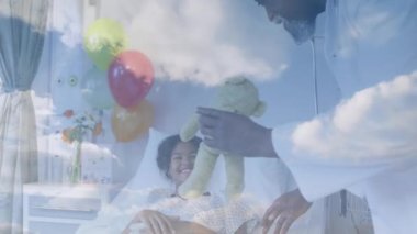 Mutlu Afro-Amerikan doktorların, hastanede yatan kadın hastalarla oynaması üzerine bulutların animasyonu. Tıbbi ve sağlık hizmetleri konsepti dijital olarak oluşturulmuş video.