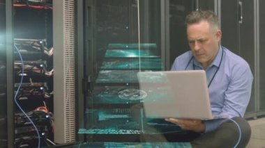 Beyaz adamın sunucu odasında dizüstü bilgisayar kullanarak veri işleme animasyonu. küresel veri işleme, hesaplama ve dijital arayüz kavramı dijital olarak oluşturulmuş video.