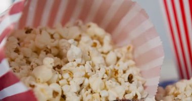 Kırmızı ve beyaz kutunun üzerinde bir kutu patlamış mısır animasyonu. Ulusal patlamış mısır günü ve dijital olarak üretilen video konsepti.