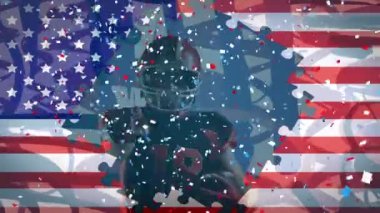 Amerikan futbolcusu üzerine Amerikan bayrağı ve konfeti animasyonu. küresel spor, rekabet ve vatanseverlik kavramı dijital olarak üretilen video.