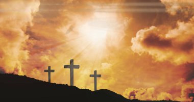 Image of three christian crosses with glowing sun rays over orange sky. easter celebration, religion and tradition concept digitally generated image.