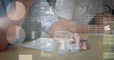 Image of statistics and financial data processing over business people in meeting. global business and data processing concept digitally generated image.