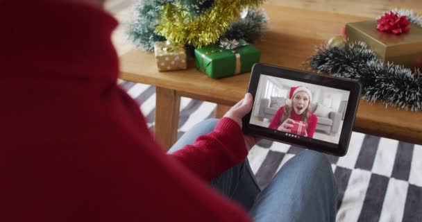 画面上の笑顔の女性とクリスマスビデオコールのためのタブレットを振って使用してアルビノの男 クリスマスやお祭りや通信技術は — ストック動画
