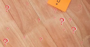 Animation of red question marks over multicolour memo notes on wooden background. trivia day, education and learning concept digitally generated video.