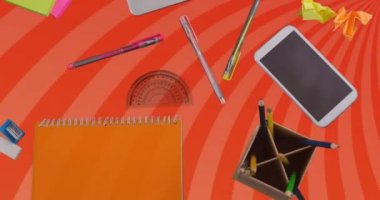 Animation of laptop and office items over orange spinning stripes. business, office and tidy work space concept digitally generated video.