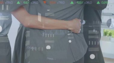 Animation of financial data processing over diverse business people embracing. global business, finances, connections and digital interface concept digitally generated video.