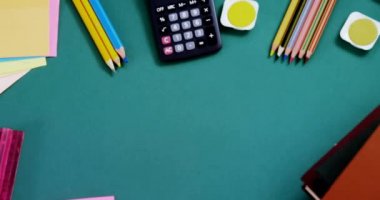 Animation of happy substitute day text over school items on green background. education, knowledge and school concept digitally generated video.