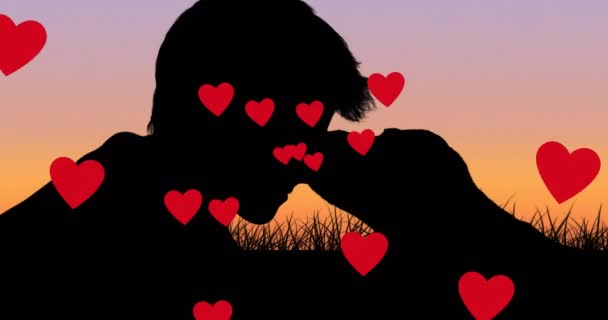 Diverse Icone Rosse Del Cuore Che Galleggiano Contro Silhouette Ragazzo — Video Stock