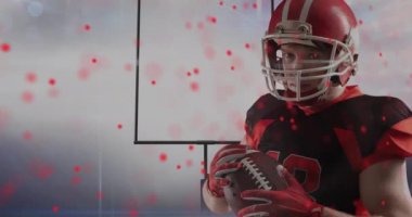 Amerikan futbolcusu ve top üzerinde kırmızı noktaların canlandırılması. spor ve kutlama konsepti dijital olarak oluşturulmuş video.