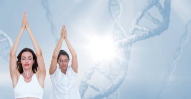 DNA yapılarına karşı yoga yapan iki kadın ve mavi arka planda fotokopi alanı. Tıp bilimi ve sağlıklı yaşam tarzı konsepti