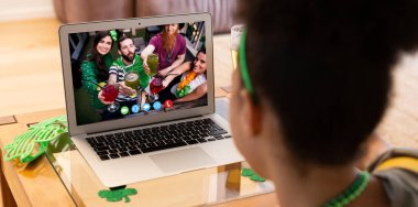 Afro-Amerikalı bir kadının evinde dizüstü bilgisayarından bir video görüşmesi var. Aziz Patrick 'in kutlama konsepti