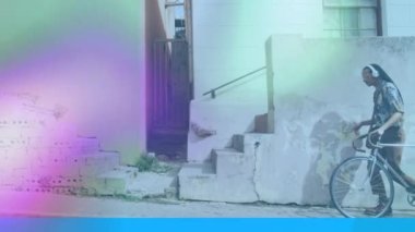 Bisikletle yürüyen Afro-Amerikan bir adamın üzerinde hareket eden şekillerin animasyonu. pedal günü ve dijital olarak üretilen video konsepti.