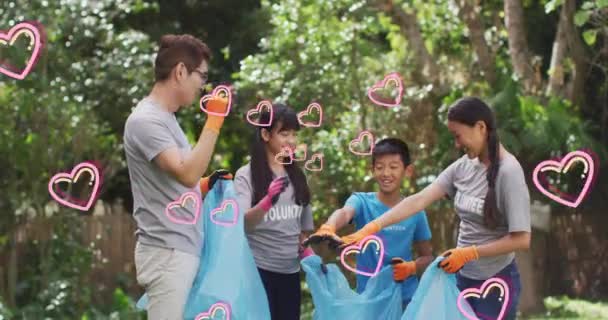 Animation Heart Icons Moving Happy Asian Family Cleaning Rubbish Countryside — Vídeo de Stock