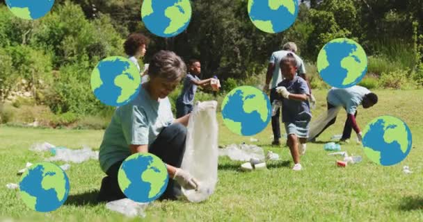 Animation Falling Globes Happy Diverse Group Picking Rubbish Countryside Eco — Stock Video