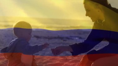 Kolombiya bayrağının animasyonu, kumsalda oynayan çocuklu, mutlu beyaz bir annenin üzerinde. Vatanseverlik ve kutlama konsepti dijital olarak oluşturulmuş video.