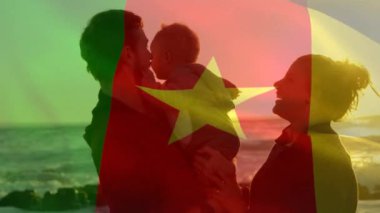 Kamerun bayrağının sahilde çocuklu beyaz ebeveynler üzerinde canlandırılması. Vatanseverlik ve kutlama konsepti dijital olarak oluşturulmuş video.