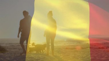 Belçika bayrağının sahilde çocuklu ve köpekli beyaz ebeveynler üzerinde canlandırılması. Vatanseverlik ve kutlama konsepti dijital olarak oluşturulmuş video.